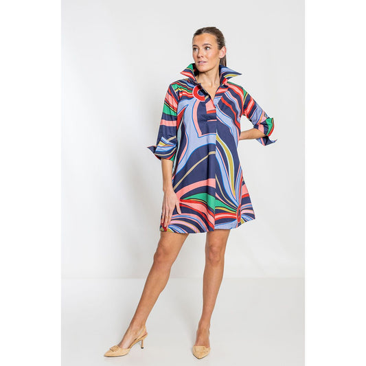 Woman wearing a colorful patterned dress on a white background