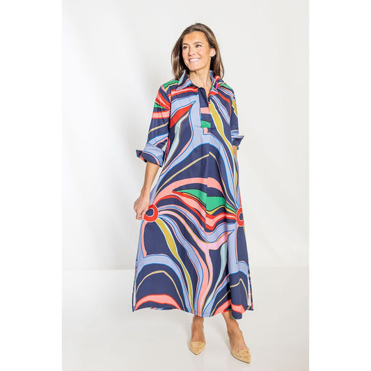Woman wearing a colorful, patterned dress on a white background