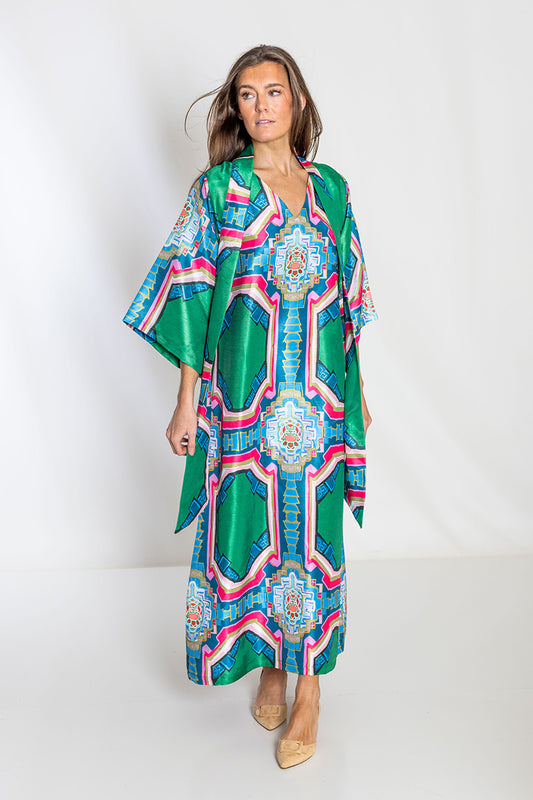 Woman wearing a colorful patterned dress on a white background